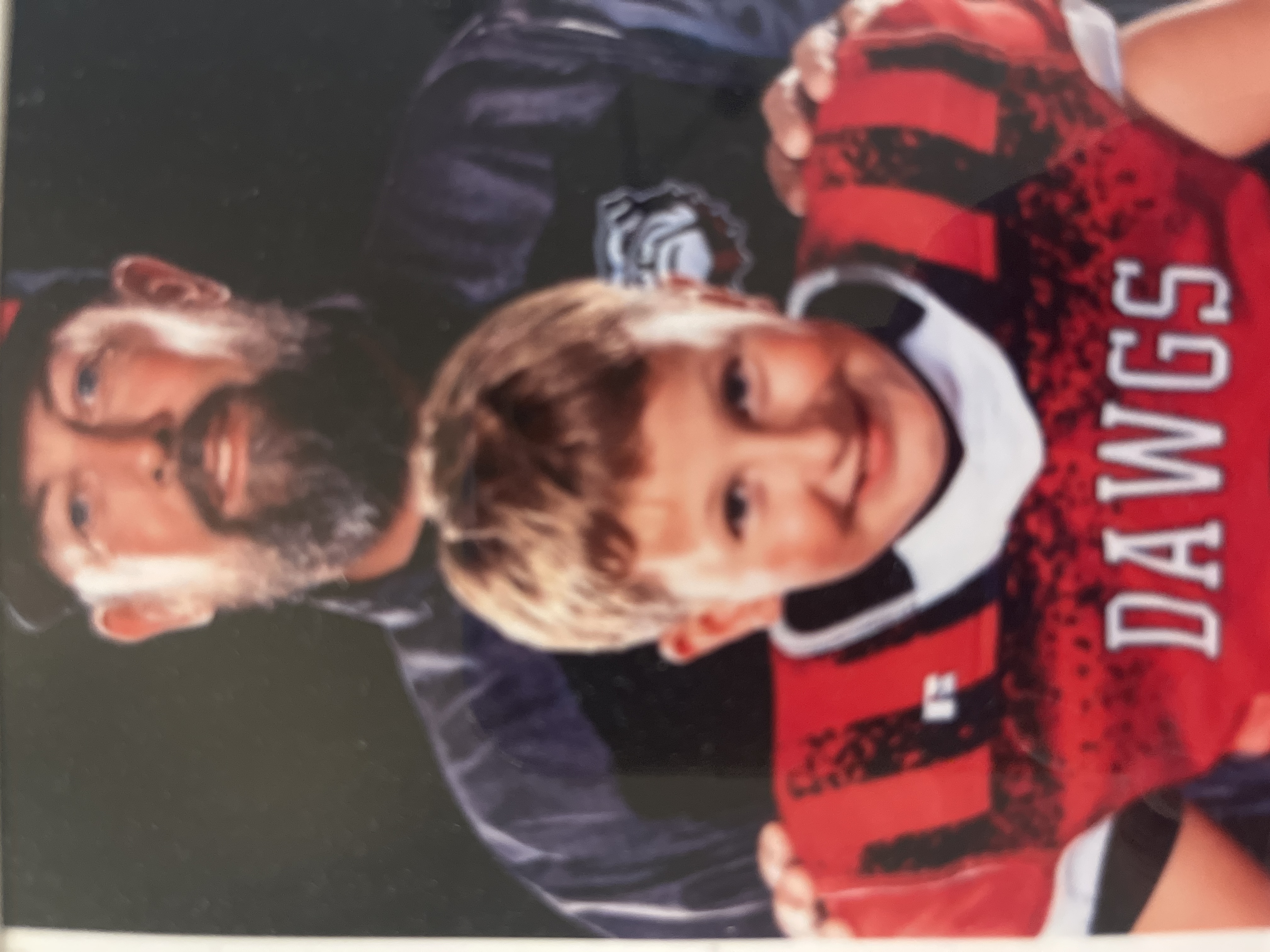 Coach Shawn Tankersley with a youth football player